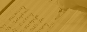 A yellow filtered image with someone writing a ledger of notes.