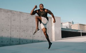 A man doing a high knees drill